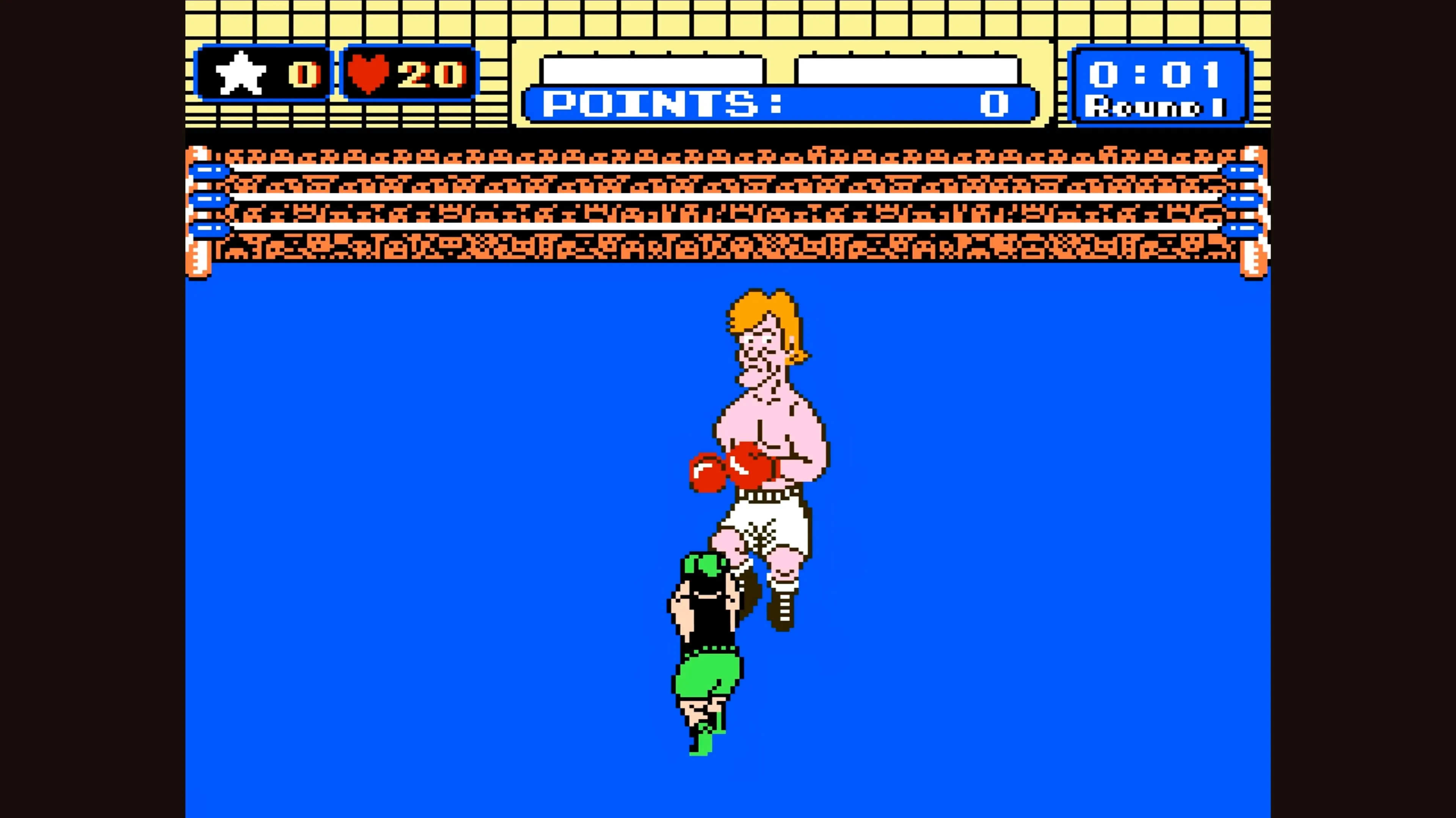 Cảnh gameplay Punch-Out!! hiển thị Little Mac đối đầu với một đối thủ tóc vàng, tập trung vào góc nhìn người thứ nhất.