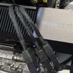 Card đồ họa Nvidia GeForce RTX 4080 Super FE với ba dây cấp nguồn được cắm vào bộ chuyển đổi, minh họa cho mức tiêu thụ điện năng hiệu quả của dòng RTX 40.