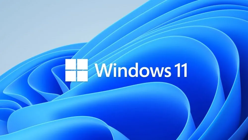 Giao diện màn hình nền Windows 11 với hình nền màu xanh, minh họa môi trường hoạt động của hệ điều hành