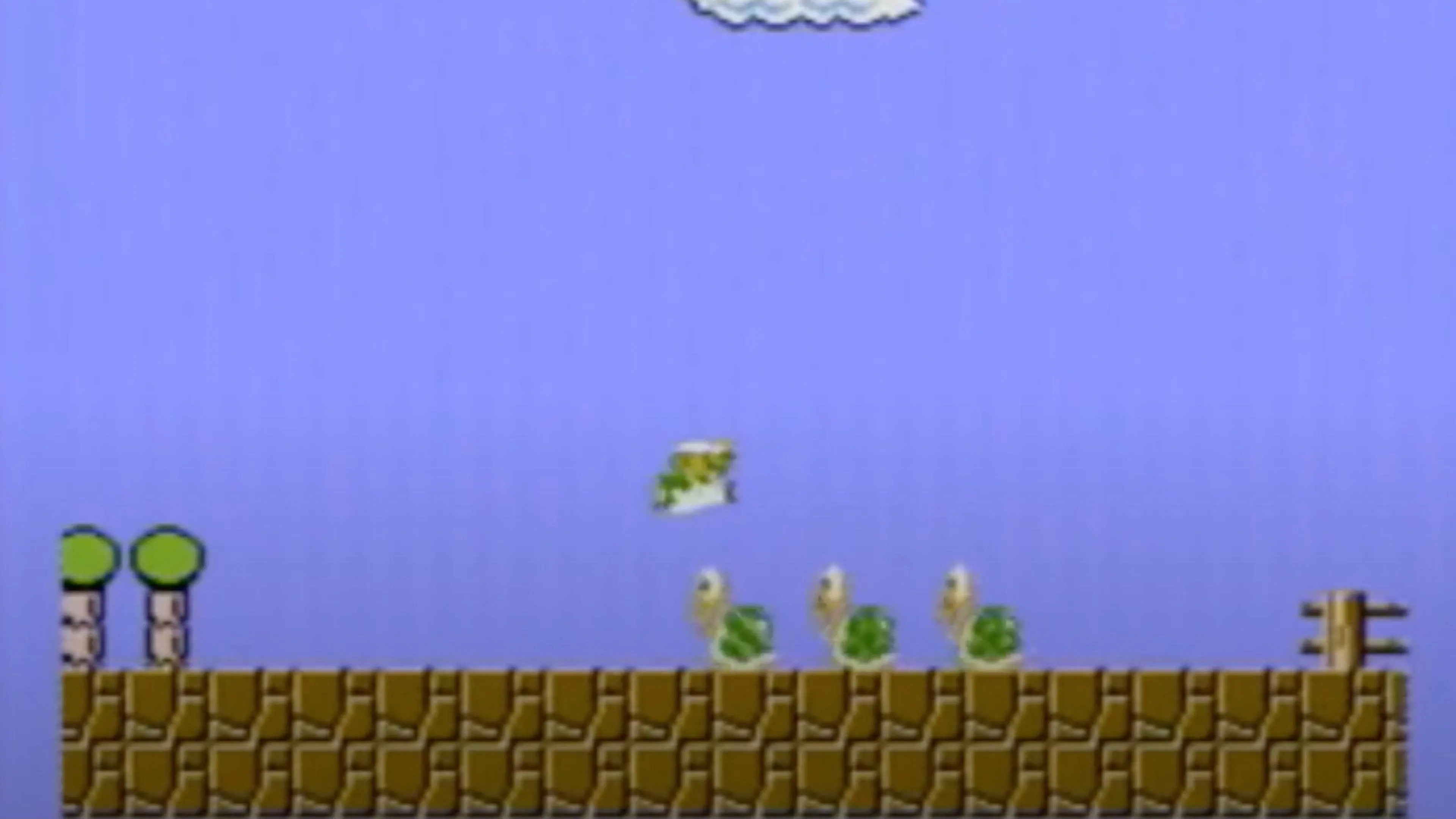 Màn hình chơi Super Mario Bros. hiển thị Mario đang đối đầu với Bowser trong lâu đài cuối cùng.