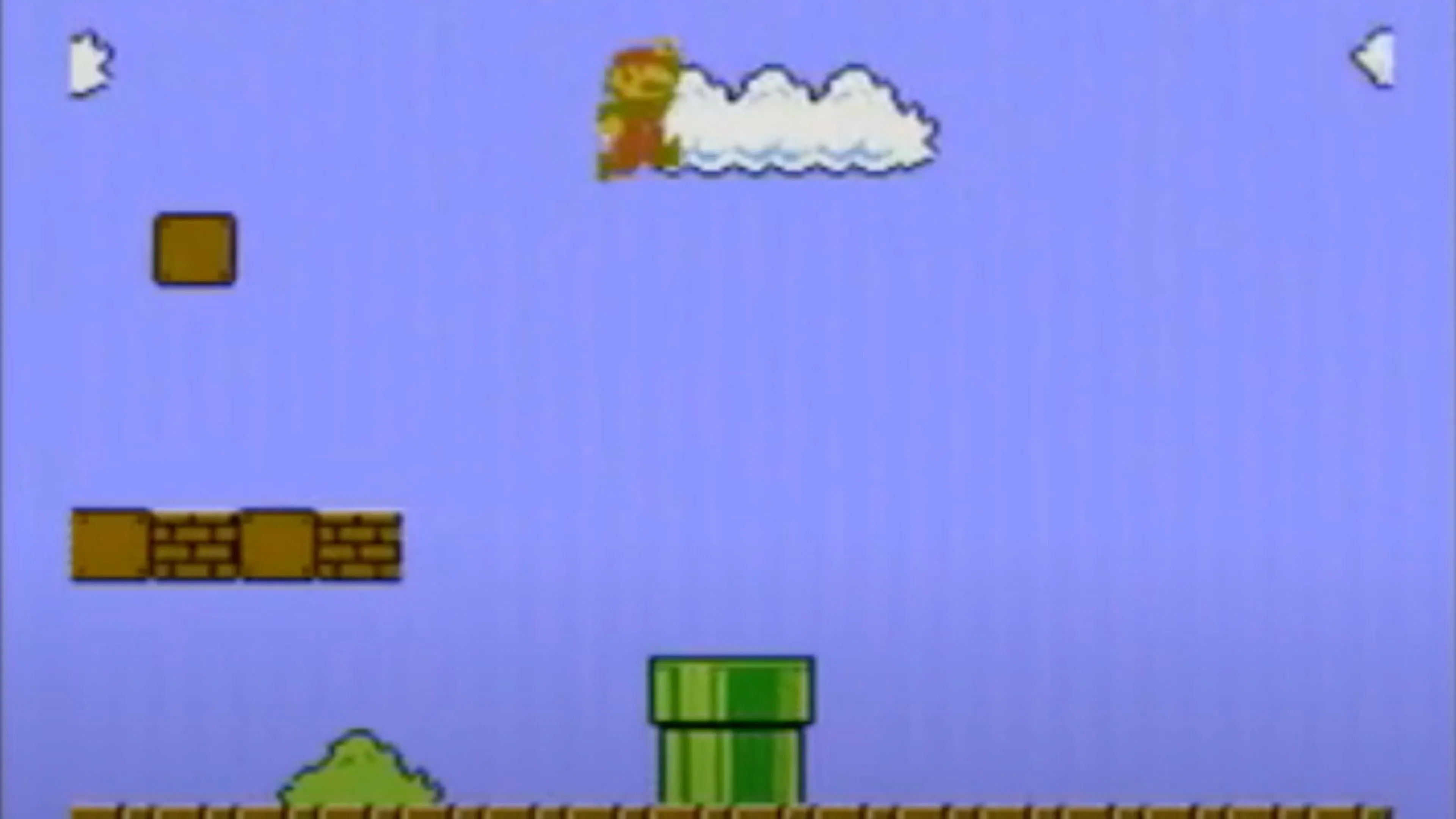 Màn hình gameplay của Super Mario Bros. với Mario đang nhảy qua nấm Goomba và khối gạch.