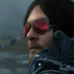 Sam Porter Bridges đeo kính râm trong game Death Stranding, thể hiện phong cách của người giao hàng qua vùng đất hoang tàn.