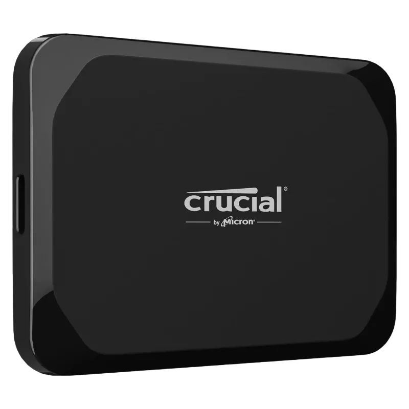 SSD di động Crucial X9 4TB với thiết kế màu đen nhỏ gọn và sang trọng, nằm trên bề mặt phản chiếu.